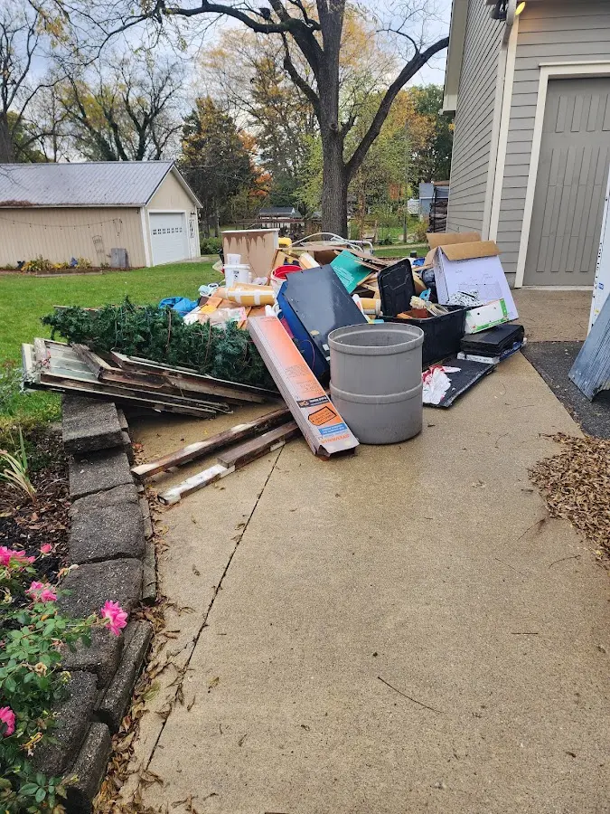 Dumpster being loaded with debris for 3 Yard Dumpster Rental in Poplar Bluff